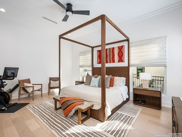 bedroom with ceiling fan, ornamental molding, and light wood-type flooring