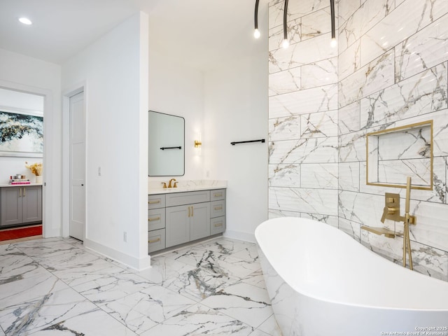 bathroom with vanity and a tub