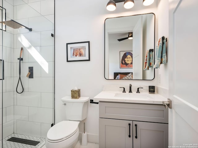 bathroom featuring vanity, toilet, and a tile shower