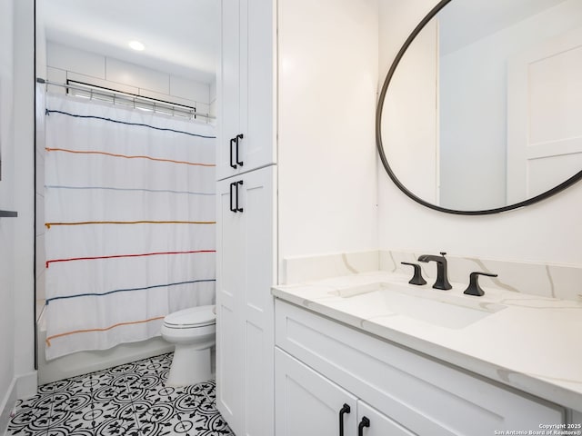 bathroom featuring tile patterned floors, vanity, and toilet