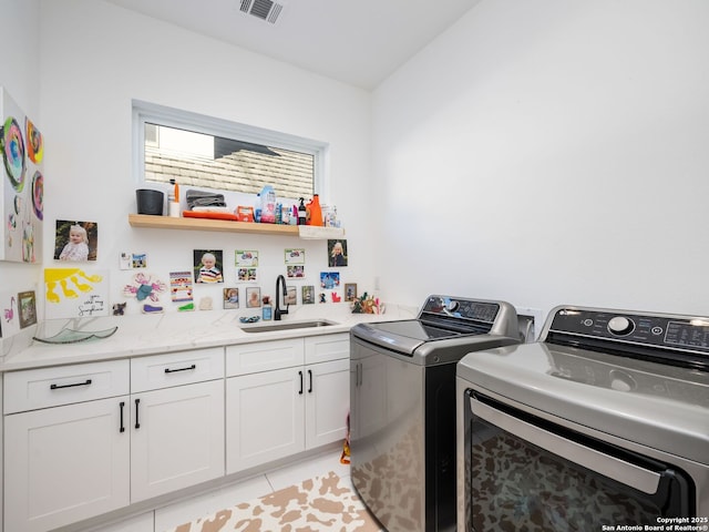 laundry room featuring separate washer and dryer, sink, cabinets, and light tile patterned flooring