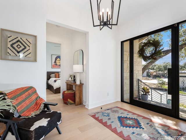 entryway featuring a chandelier and light wood-type flooring