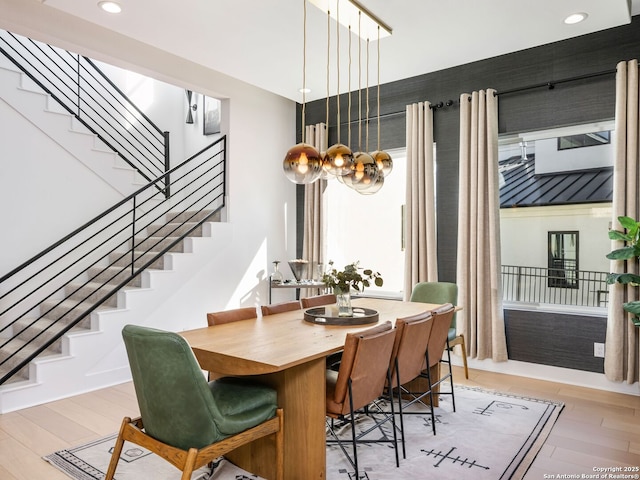 dining room with an inviting chandelier and light hardwood / wood-style floors