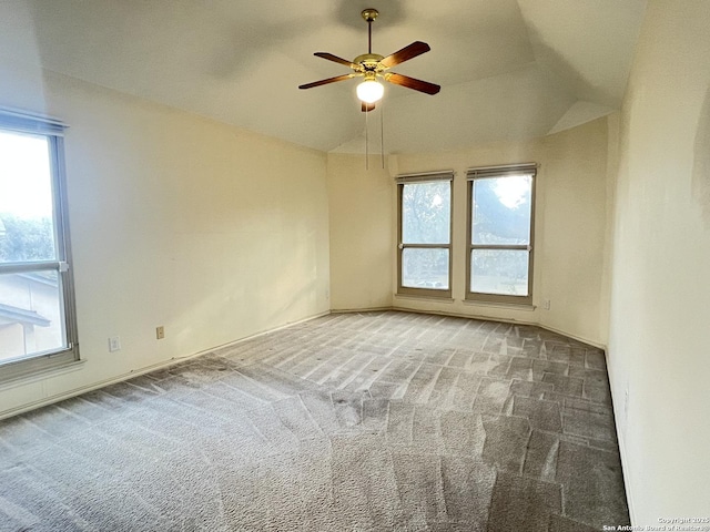 carpeted empty room featuring ceiling fan and vaulted ceiling