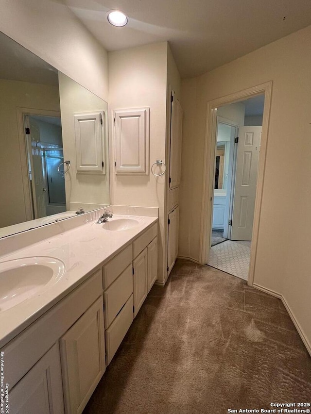 bathroom featuring vanity and a shower with door