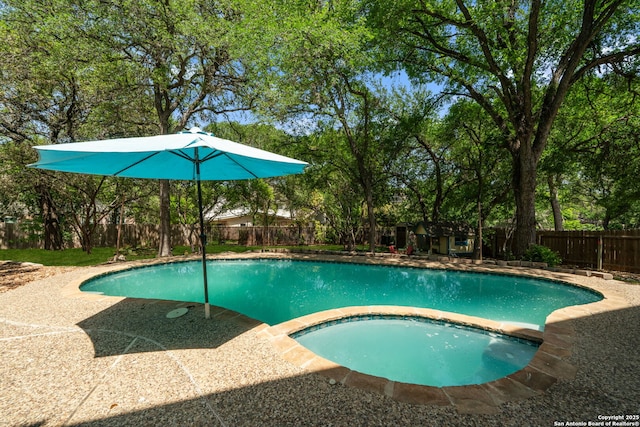 1219 Vista Del Juez, San Antonio, TX 78216 - view of swimming pool with a fenced backyard, a pool with connected hot tub, an outbuilding, and a patio