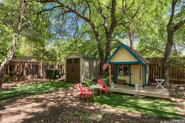 1219 Vista Del Juez, San Antonio, TX 78216 - back of house with a fenced backyard, an outdoor structure, a storage unit, and a wooden deck