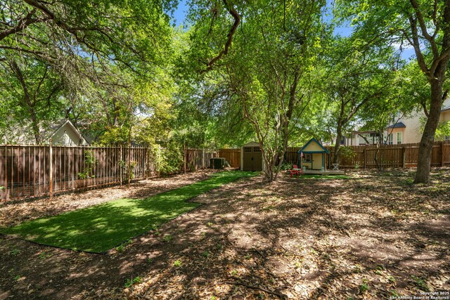 1219 Vista Del Juez, San Antonio, TX 78216 - fenced backyard featuring a storage unit and an outbuilding
