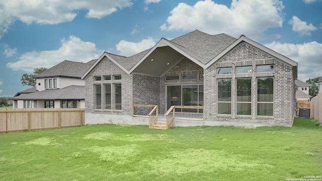 10310 Redding Bnd, San Antonio, TX 78254 - rear view of house featuring brick siding, a lawn, and fence