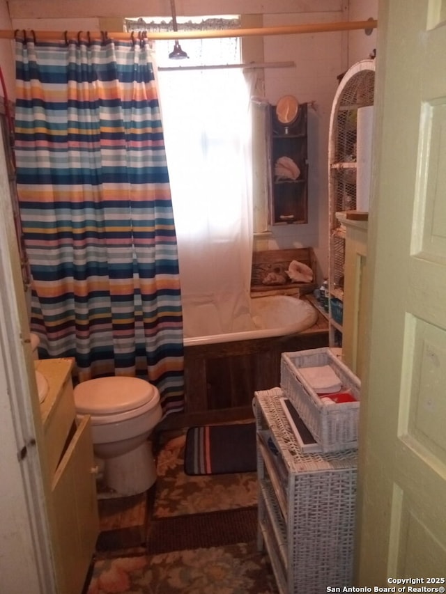 full bathroom featuring shower / bath combination with curtain, vanity, and toilet