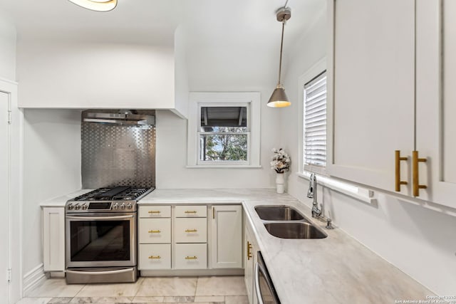 kitchen with pendant lighting, sink, backsplash, stainless steel appliances, and range hood