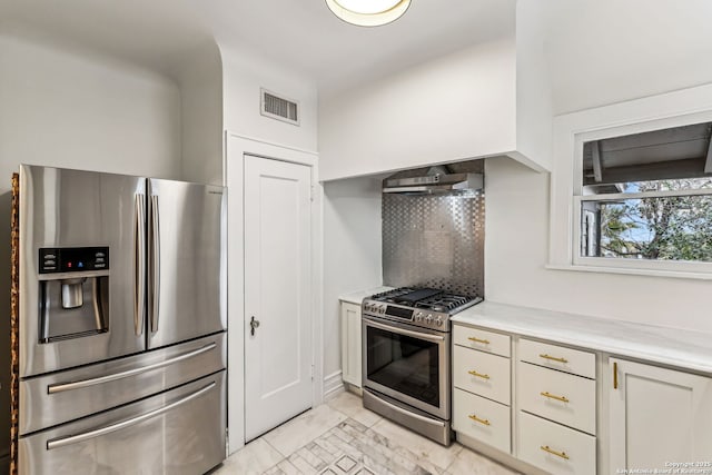 kitchen featuring stainless steel appliances, tasteful backsplash, and wall chimney exhaust hood