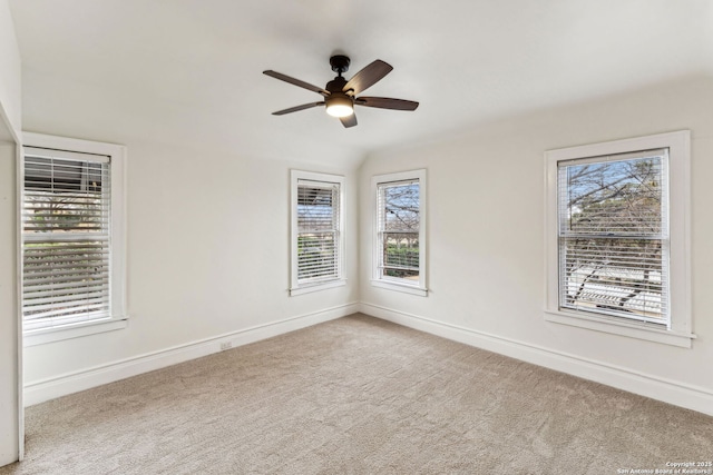 carpeted spare room featuring ceiling fan