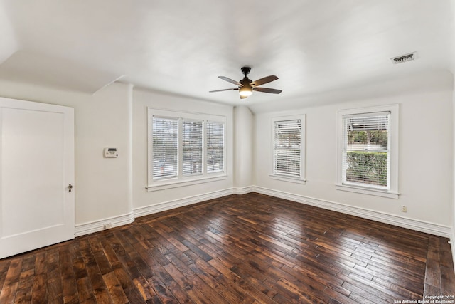 empty room with dark wood-type flooring and ceiling fan