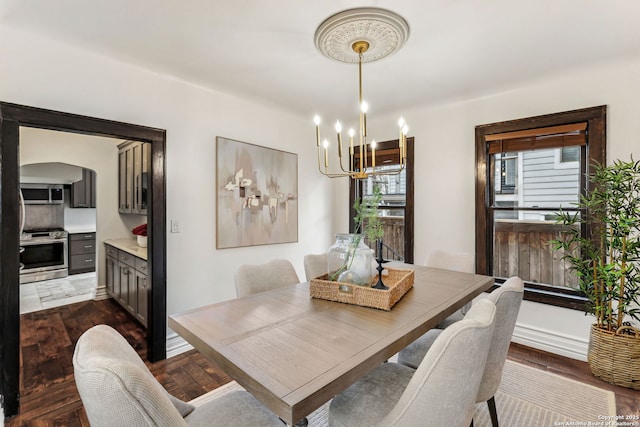 dining space featuring dark hardwood / wood-style floors and a notable chandelier