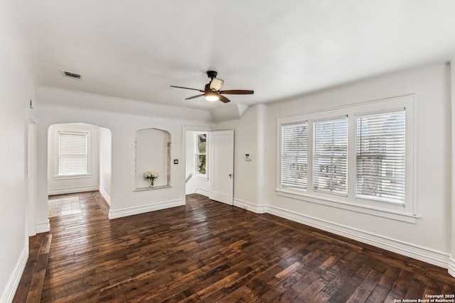 spare room with ceiling fan and dark hardwood / wood-style flooring