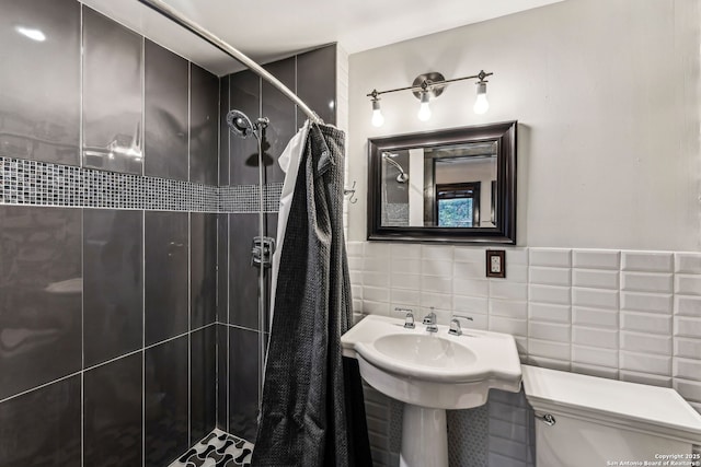 bathroom with toilet, tile walls, and a shower with shower curtain