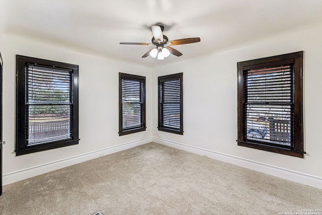 carpeted empty room with ceiling fan