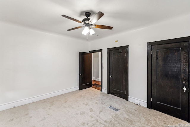 unfurnished bedroom featuring ceiling fan and carpet floors