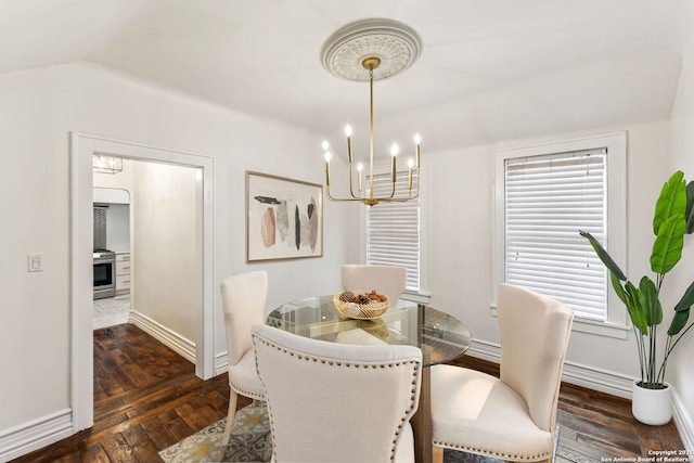 dining area with dark wood-type flooring and a notable chandelier