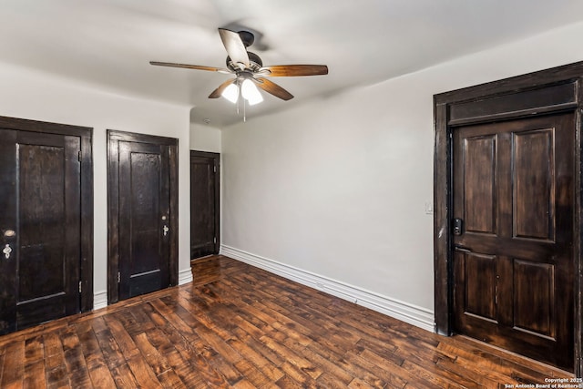 unfurnished bedroom featuring dark wood-type flooring and ceiling fan