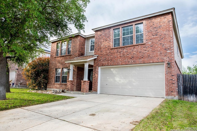 view of front of property featuring a garage and a front lawn