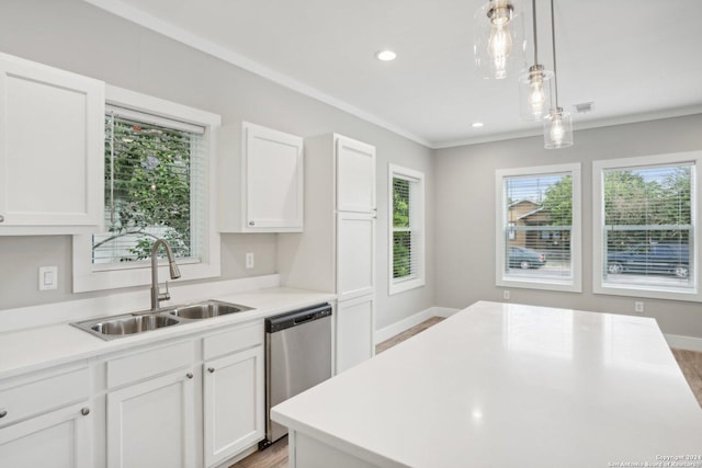 kitchen featuring a wealth of natural light, white cabinetry, sink, hanging light fixtures, and stainless steel dishwasher