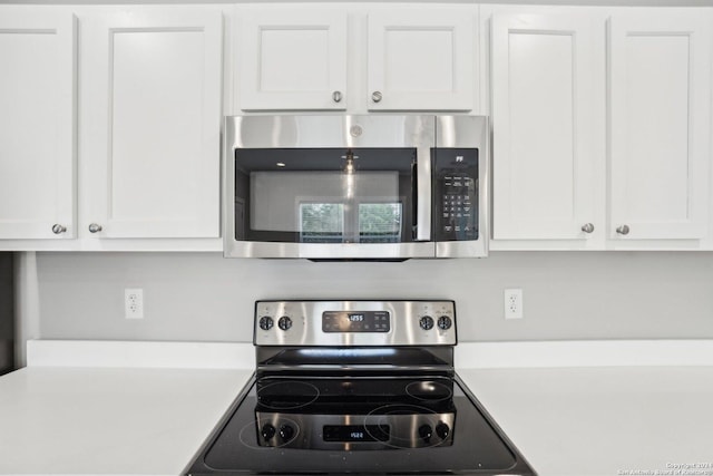 kitchen featuring white cabinetry and stainless steel appliances