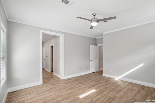 spare room with crown molding, ceiling fan, and light hardwood / wood-style floors