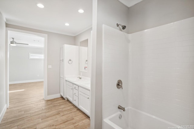 bathroom with vanity, ornamental molding, ceiling fan, shower / bath combination, and hardwood / wood-style floors