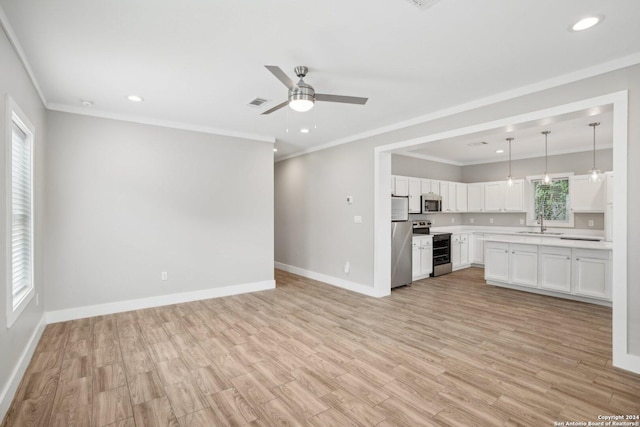 unfurnished living room with ceiling fan, ornamental molding, light hardwood / wood-style floors, and a wealth of natural light