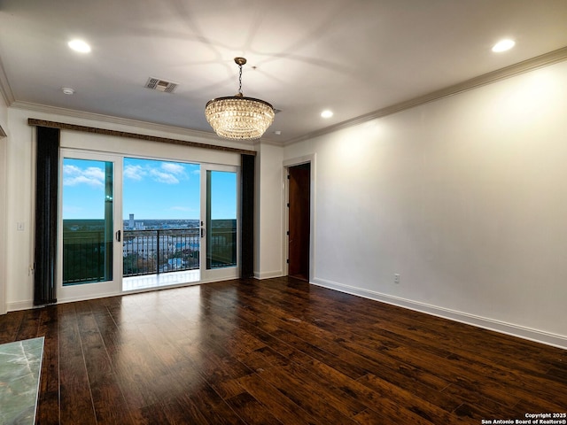 empty room with ornamental molding, dark hardwood / wood-style floors, and an inviting chandelier