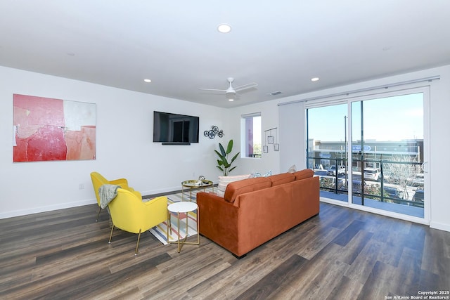 living room with dark hardwood / wood-style floors and ceiling fan