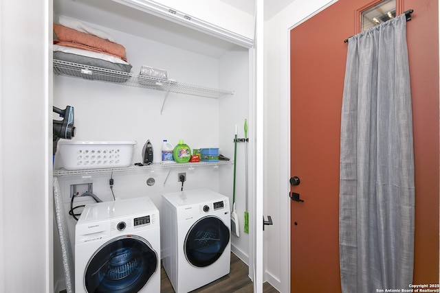 laundry area featuring dark wood-type flooring and washer and clothes dryer