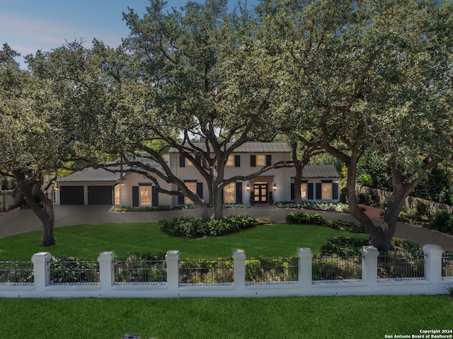 view of front of property with a garage and a front lawn