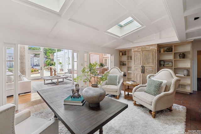 sunroom featuring vaulted ceiling with skylight and french doors