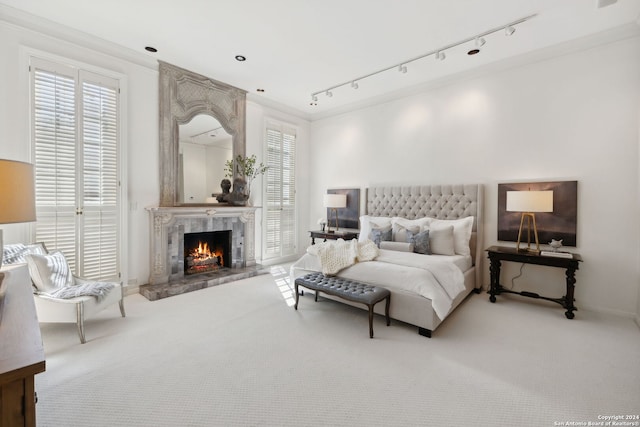 bedroom featuring a premium fireplace and carpet flooring