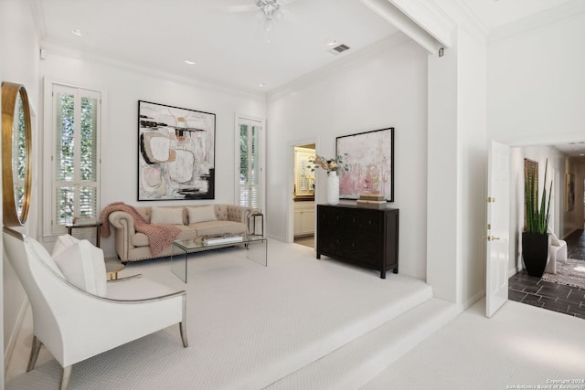 sitting room with a high ceiling, crown molding, and carpet flooring