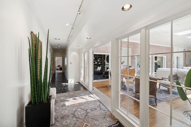 corridor with ornamental molding, track lighting, and french doors