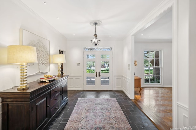 foyer with french doors and crown molding