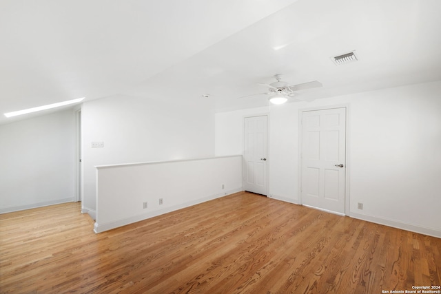 additional living space featuring vaulted ceiling, ceiling fan, and light hardwood / wood-style floors