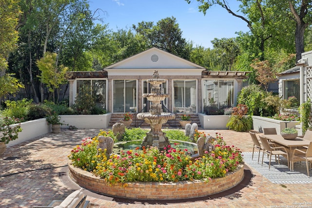 rear view of property featuring a sunroom and a patio