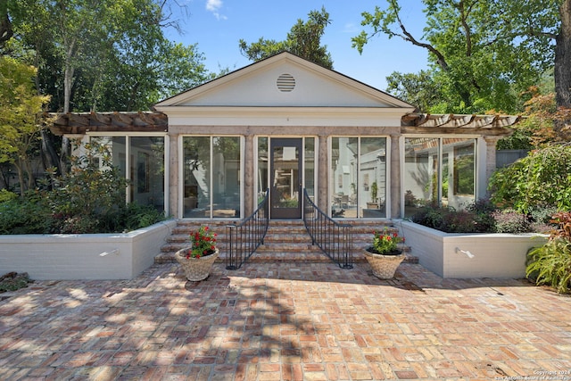 view of front facade featuring a patio and a sunroom