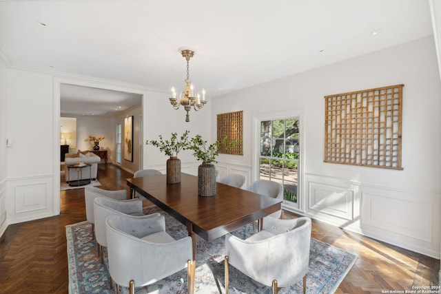 dining space featuring parquet floors and an inviting chandelier