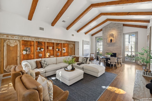 living room with beam ceiling, dark wood-type flooring, and high vaulted ceiling