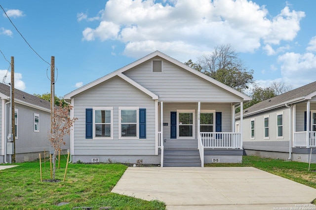 bungalow-style house featuring covered porch and a front lawn