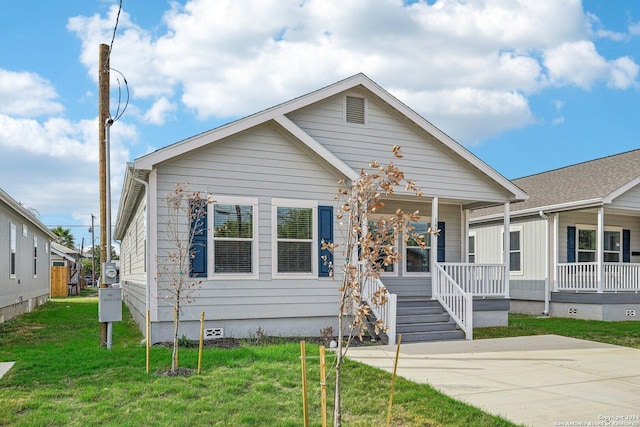 bungalow featuring a front lawn and a porch