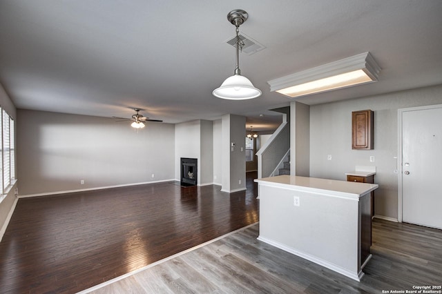 kitchen with dark hardwood / wood-style flooring, decorative light fixtures, a center island, and ceiling fan