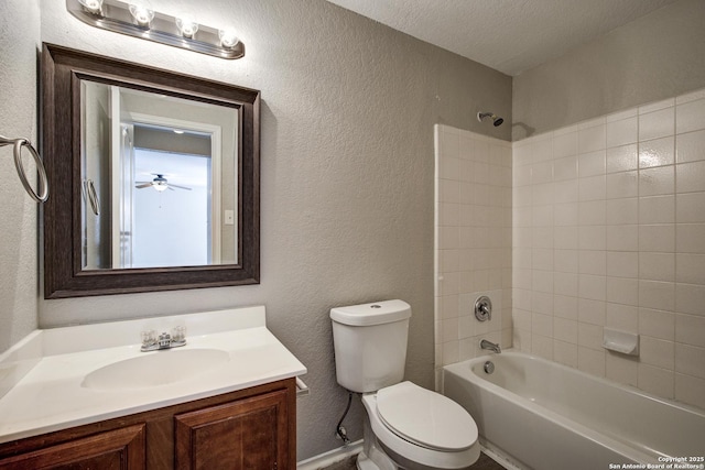 full bathroom with vanity, tiled shower / bath combo, a textured ceiling, and toilet