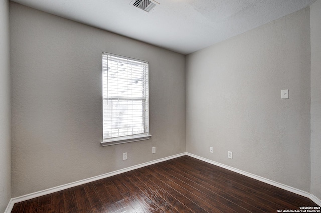 empty room with dark hardwood / wood-style floors